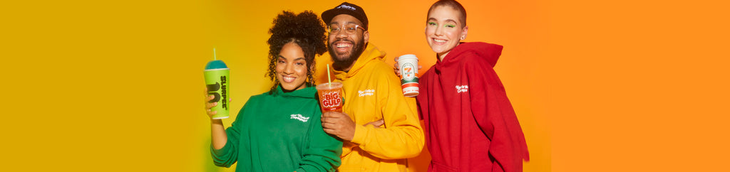 Three people wearing green, orange, and red sweatshirts.