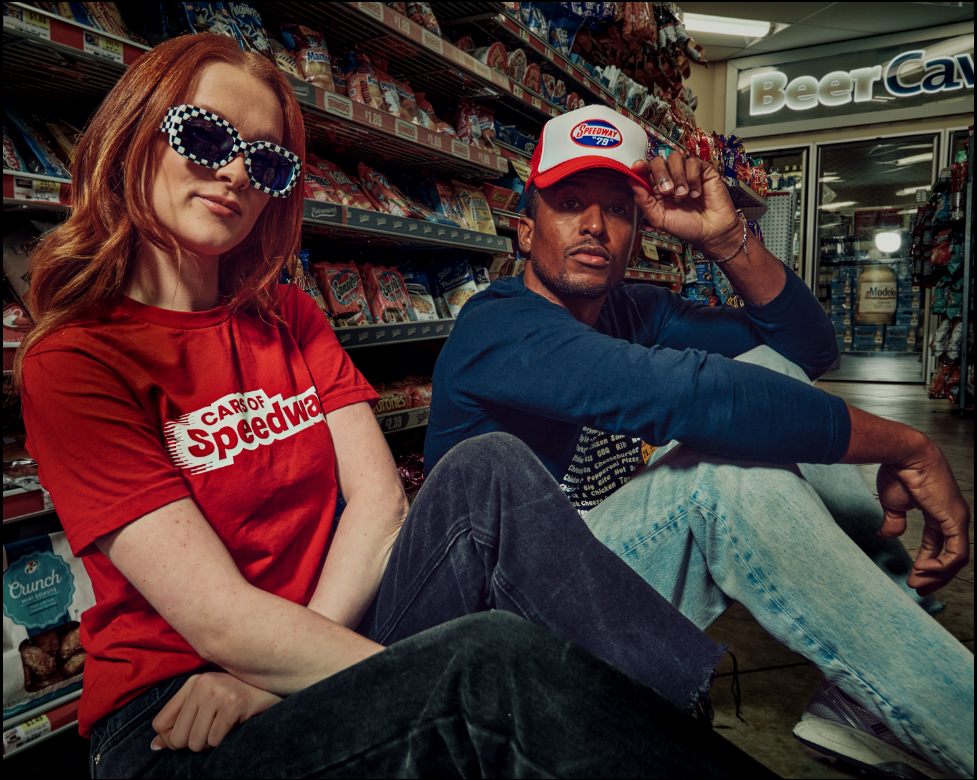 Man and woman in a Speedway store wearing Speedway merchandise