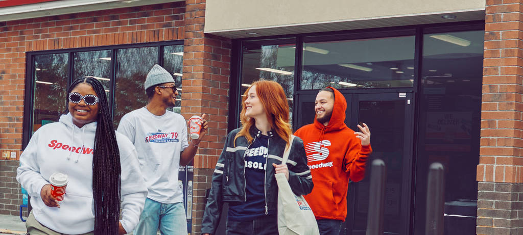 Group of people wearing Speedway merchandise. Shop the Speedway collection