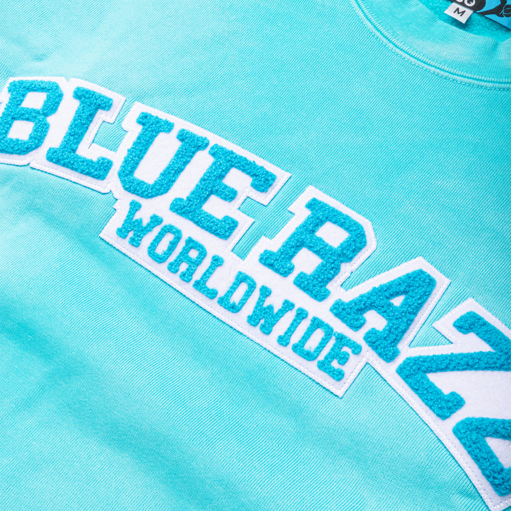 Slurpee blue tie dye sweater that says "Blue Razz Worldwide"