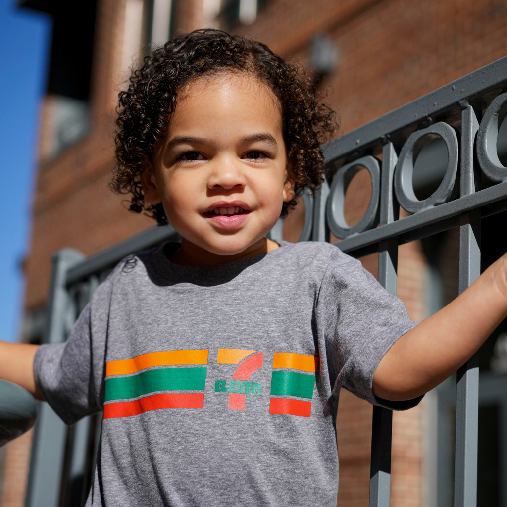 Child wearing a 7-Eleven classic logo t-shirt