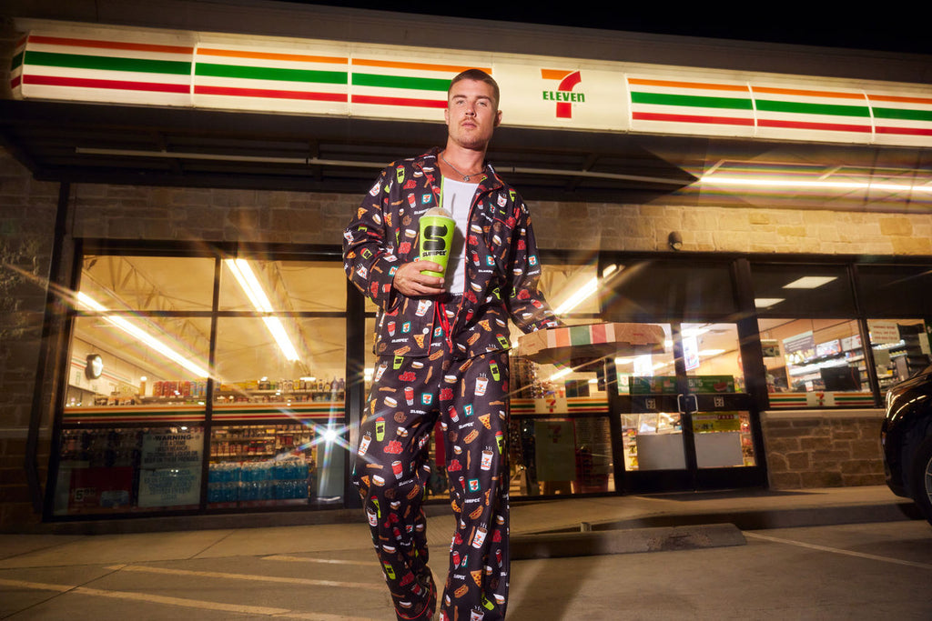 man wearing 7-Eleven pajama set with snack print
